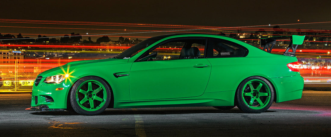 BMW Individual Signal Green E92 M3 side profile photographed at night with motorsport-inspired styling upgrades