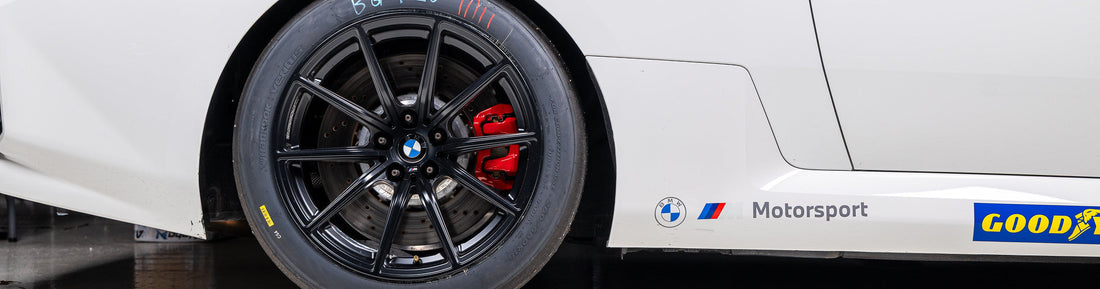 BMW Motorsport G87 M2 Racing Black 18x10 Wheel Set installed on a BMW M2 Racing, showing the passenger-side rear wheel profile and factory-developed motorsport wheel design for track competition.