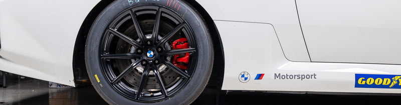 BMW Motorsport G87 M2 Racing Black 18x10 Wheel Set installed on a BMW M2 Racing, showing the passenger-side rear wheel profile and factory-developed motorsport wheel design for track competition.