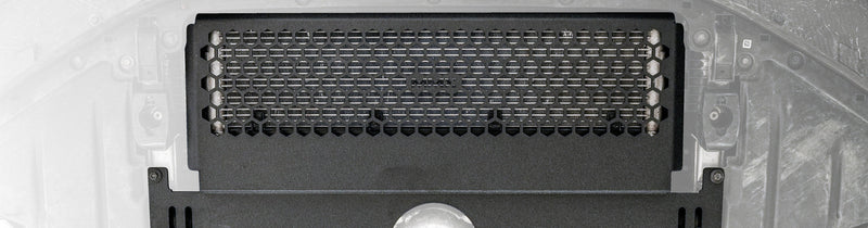 Close-up of the MMX Performance Oil Cooler Guard installed beneath a BMW G87 M2, showcasing the precision-formed 6061-T6 aluminum construction and optimized hexagonal grille protecting the factory S58 oil cooler.