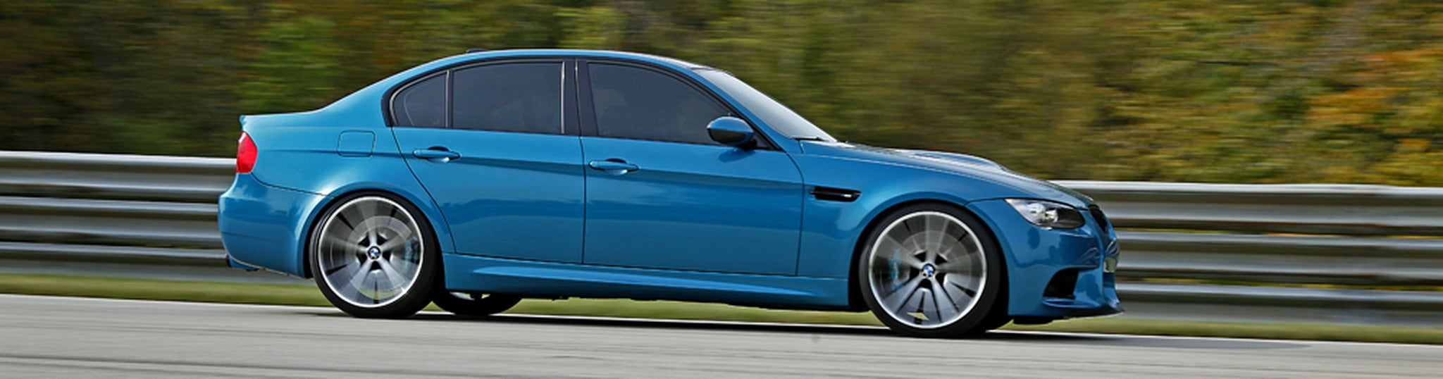 Atlantis Blue BMW E90 M3 side rolling shot on track at Autobahn Country Club with IND Portfolio aero and Neez wheels.