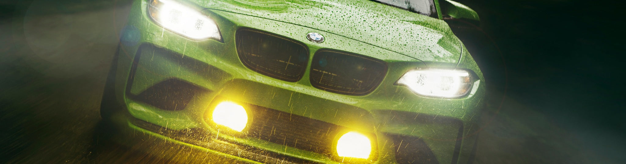 Gelbgrün BMW F87 M2 rolling through rain with M235R fog lights illuminated and BMW Motorsport-inspired aero upgrades