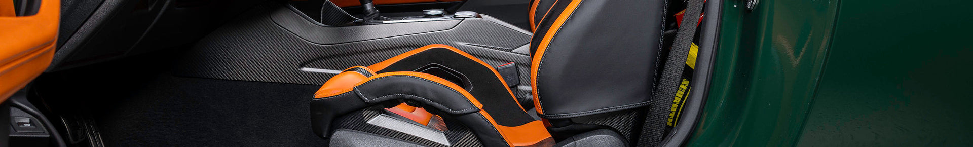Wunderworks hero image featuring IND’s BMW G82 M4 with Kyalami Orange bucket seat bolster set and black Alcantara interior accents.