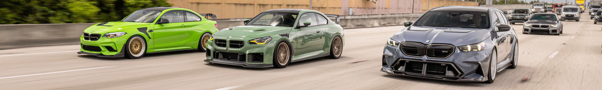 BMW M collection hero banner featuring IND’s F87 M2, G87 M2, and G99 M5 Touring rolling together on the freeway.