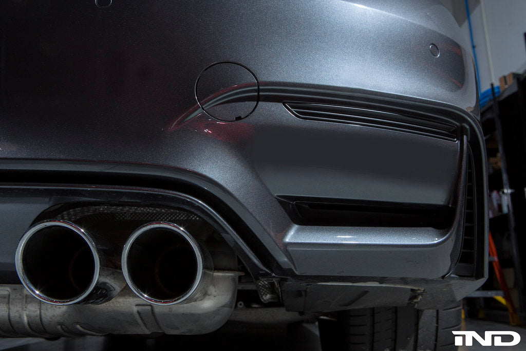 Exterior IND x Acexxon F8X M3/M4 reflector cosmetic package, showing the sleek black exterior finish and reflector details.