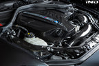 Black carbon engine cover for BMW F87 M2 N55 by Eventuri, exterior view showing sleek design and branding details.