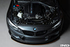 Black carbon engine cover for BMW F87 M2 N55 by Eventuri, showcasing sleek exterior design and high-quality craftsmanship.