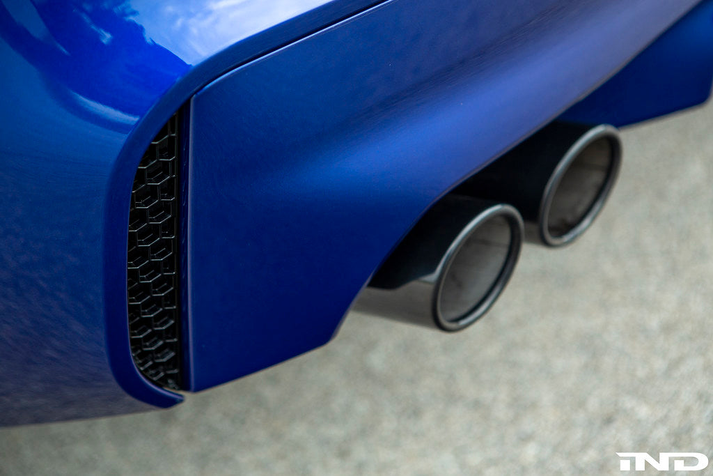 Acexxon F90 M5 rear reflector insert set with honeycomb design, exterior car accessory, shown installed on vehicle in natural setting.