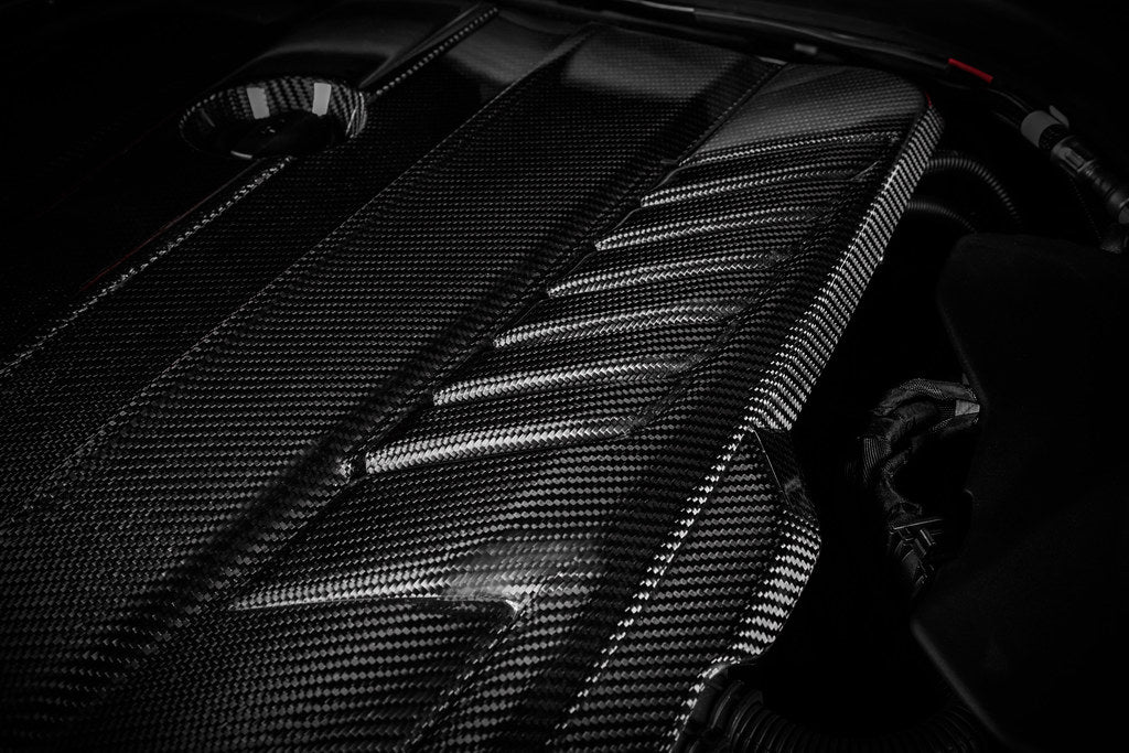 Eventuri black carbon engine cover for G29 Z4 and A90 Supra with B58 engine, exterior view showing sleek, aerodynamic design.