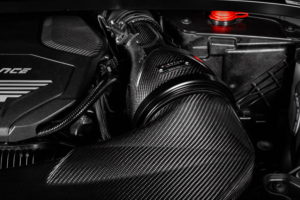 Eventuri black carbon intake system for BMW F4X M135i, M235i, F39 X2 35i B48 performance engine upgrade, close-up view of air intake components.