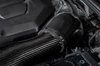 Close-up of a car engine with a carbon fiber air intake system.