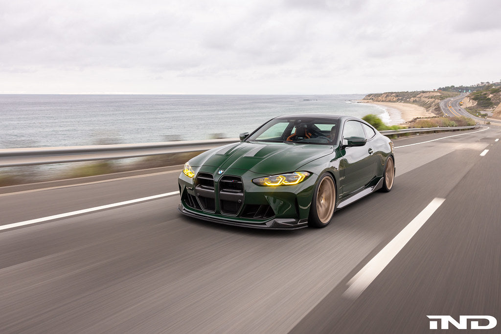 Alpha N Alpha-N G8X M3 M4 carbon vented hood installed on a car, showcasing its aerodynamic design and lightweight carbon fiber material.