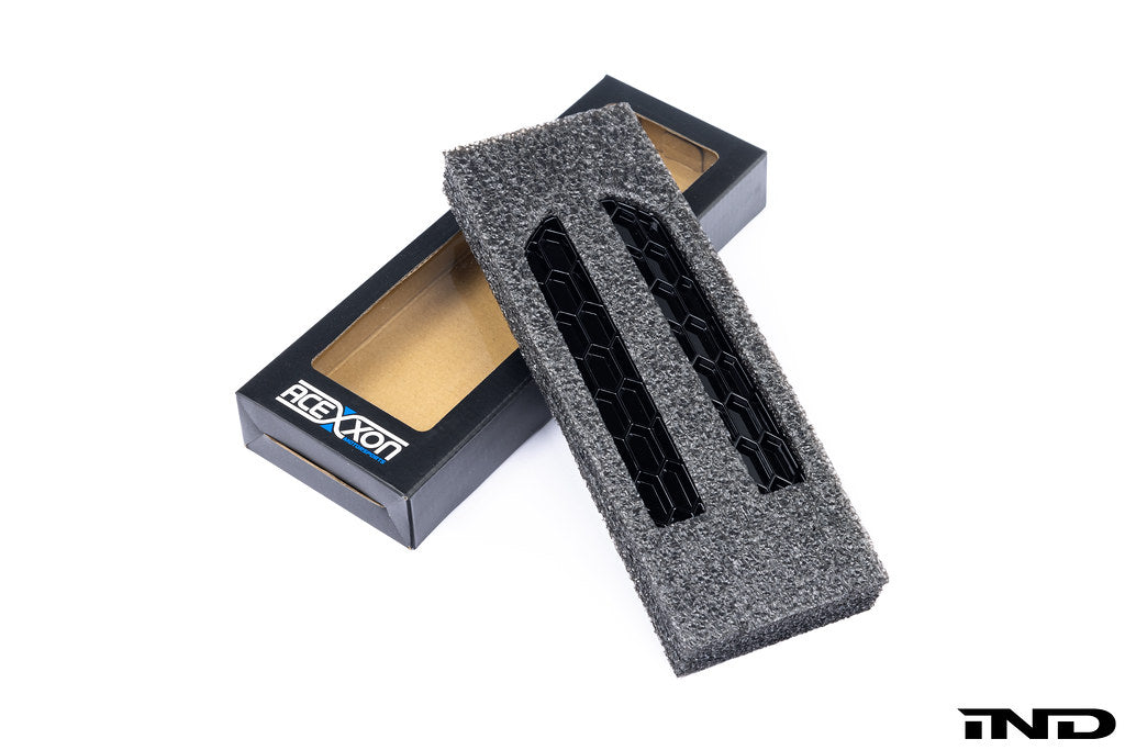 Acexxon G87 M2 rear reflector insert set for exterior vehicle lighting, shown on a car in a natural outdoor setting.
