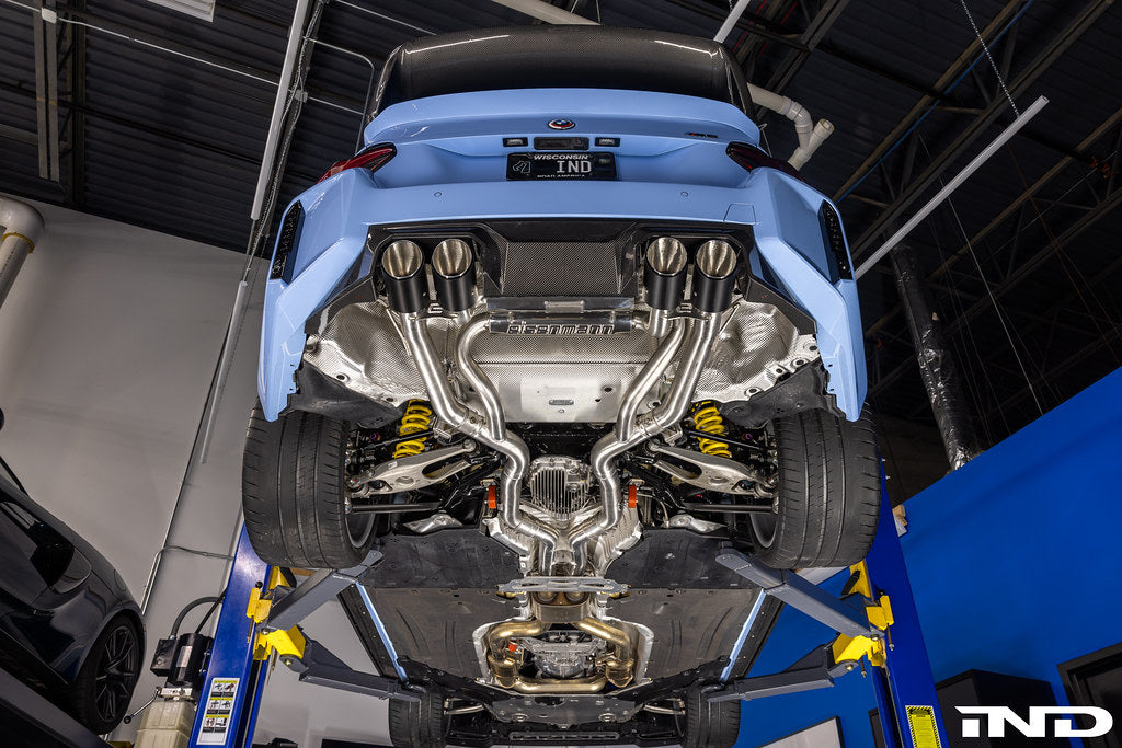 Eisenmann G87 M2 twin-flow exhaust system installed on a car, showcasing dual exhaust tips and polished metal finish.