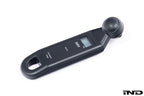 BMW electronic tire pressure gauge in a lifestyle setting, showing a compact digital display and ergonomic design.