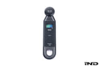 BMW electronic tire pressure gauge in a lifestyle setting, showing digital display and compact design for easy tire pressure checks.