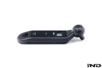 BMW electronic tire pressure gauge in a lifestyle setting, showcasing a compact digital device for accurate tire pressure measurement.