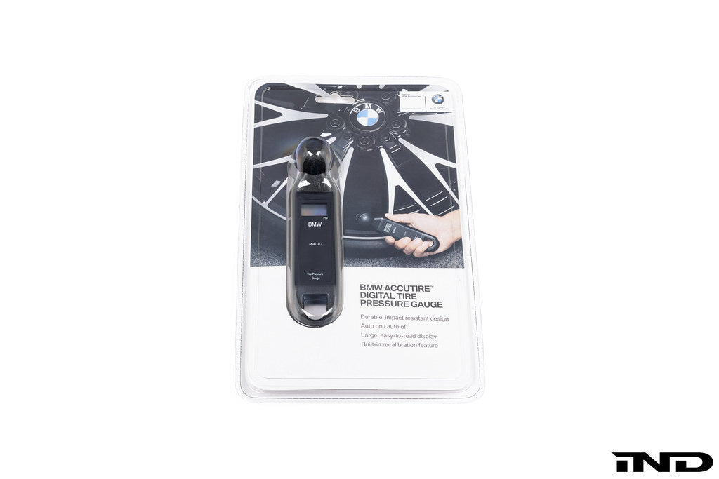 BMW electronic tire pressure gauge in use, showcasing its digital display and compact design for accurate tire pressure measurement.
