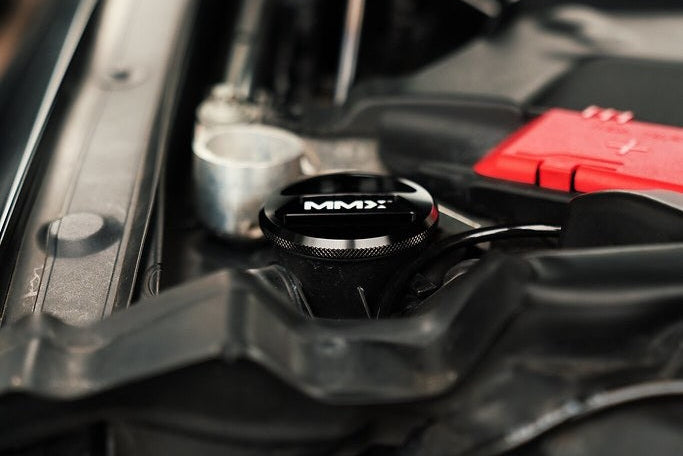 MMX Performance BMW F-Series billet washer fluid cap, sleek metal finish, designed for performance and durability.