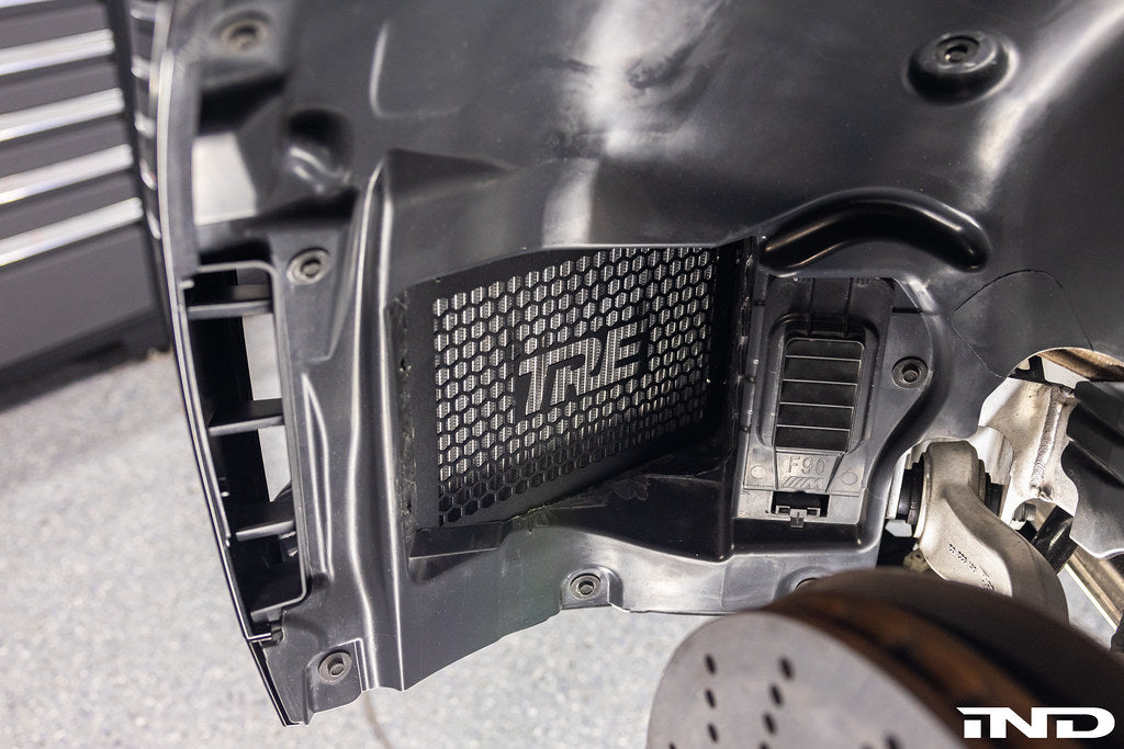 TREVORA G8X M2/M3/M4 front non-rub arch clearance kit installed on a vehicle's exterior, showcasing wheel arch modifications.