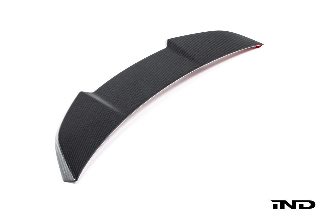 Alpha-N G90 M5 carbon rear trunk spoiler installed on a vehicle, showcasing its sleek exterior design and aerodynamic features.