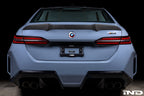 Alpha N G90 M5 carbon rear trunk spoiler on exterior of vehicle, showcasing sleek aerodynamic design and matte black finish.