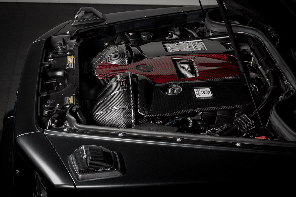 Eventuri black carbon intake system installed in a Mercedes W463A G63 AMG, showcasing high-performance engine air intake.
