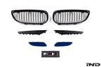 IND E9X M3 exterior cosmetic package showing carbon fiber accents and sleek aerodynamic enhancements on a black car.