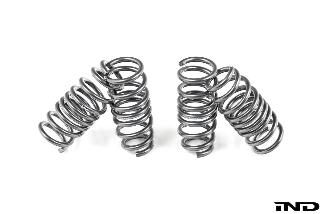 MMX Performance G90/G99 M5 xDrive suspension lowering spring set installed on a vehicle, showcasing upgraded suspension components.