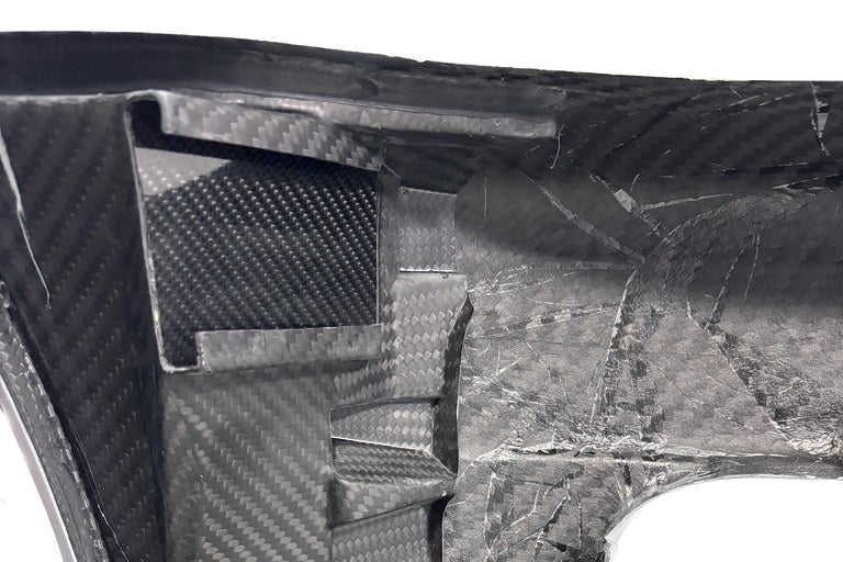 Karbonius E46 M3 carbon fiber front bumper cover for exterior styling, showcasing its sleek carbon finish and aerodynamic design.