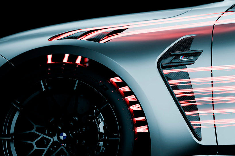 Close-up of a car's wheel and side profile with dynamic light effects on a dark background