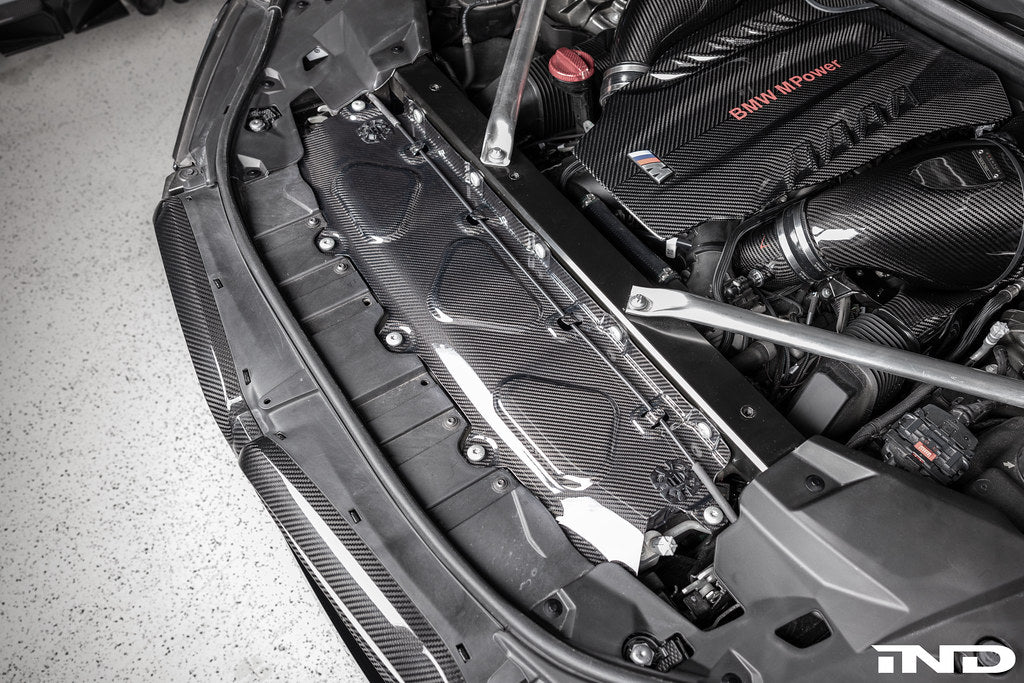 AutoTecknic dry carbon fiber cooling shroud for BMW F95 X5M, F96 X6M, and G09 XM exterior component with detailed carbon finish.