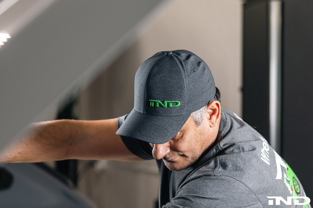 IND Signature FlexFit Hat in lifestyle setting, showing a comfortable, stylish cap with the IND brand logo on the front.