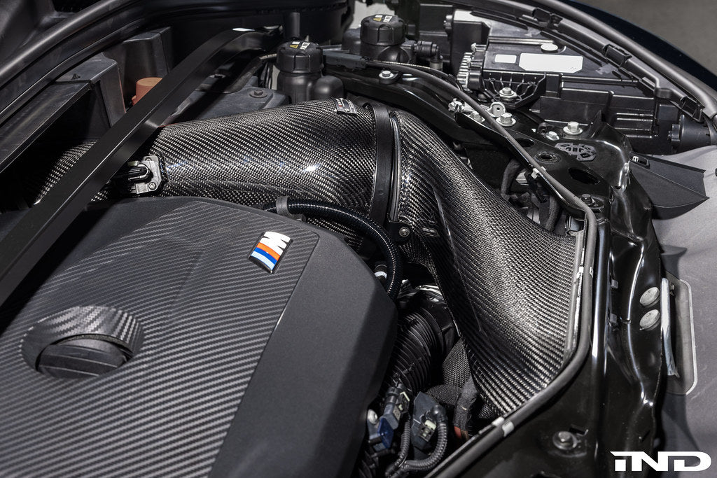 Eventuri black carbon intake system installed in BMW F7X M135 M235, X1 X2 M35i B48 performance car engine bay