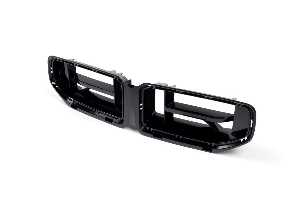 BMW G87 M2 CS front grille, exterior view showing sporty black mesh design and bold branding on the front of the car.