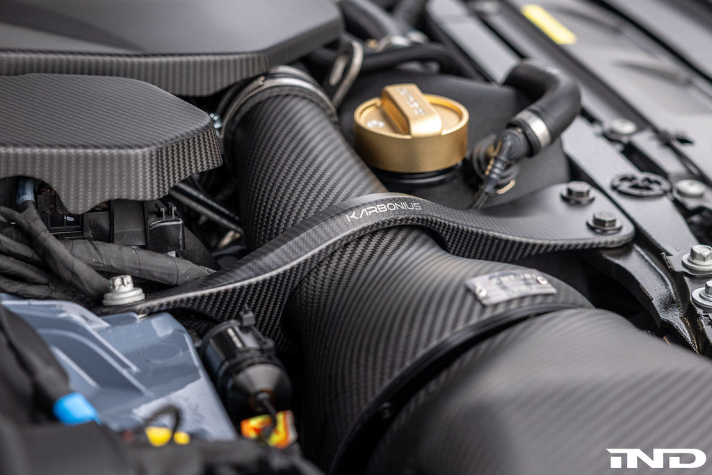 Karbonius G90/G99 M5 carbon fiber suspension strut brace set, lightweight and durable for enhanced vehicle stability.