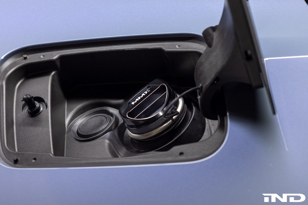 MMX Performance billet fuel cap installed on vehicle exterior, showcasing durable metal construction and sleek design.