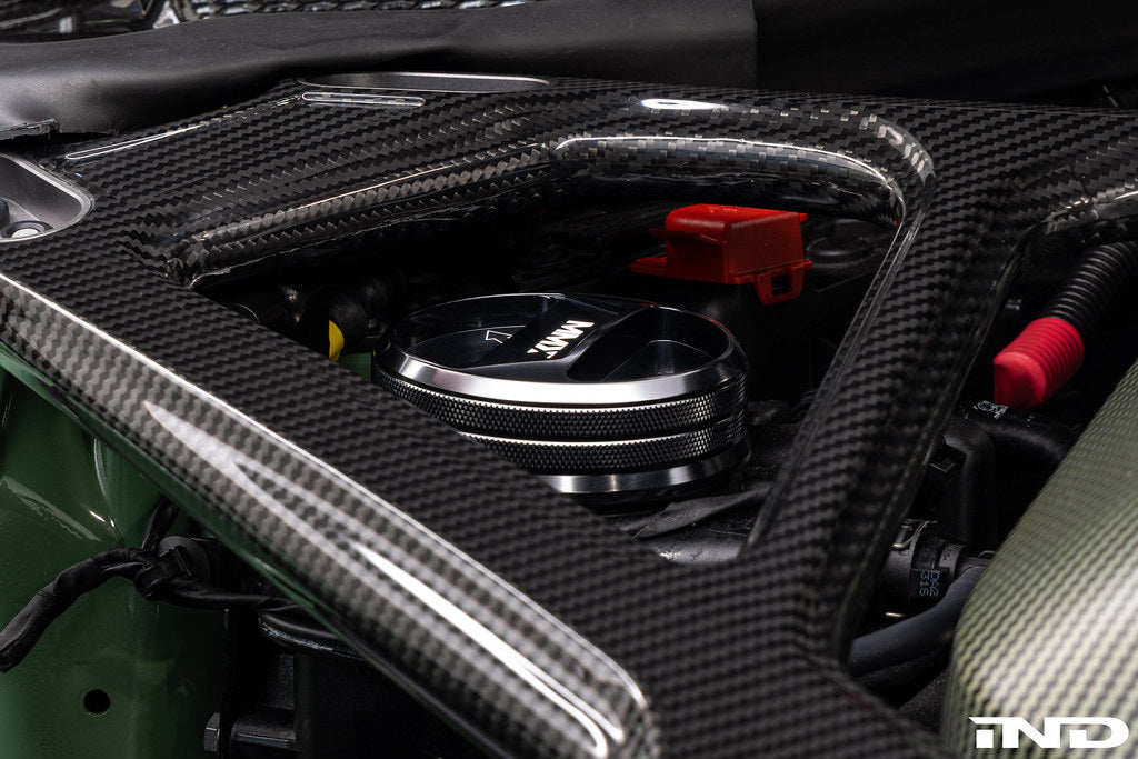 MMX Performance BMW billet coolant expansion cap with high-performance design, shown on a vehicle engine.