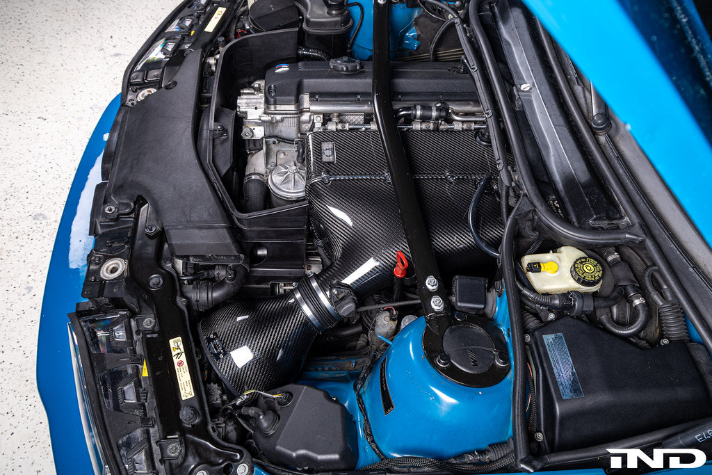 Eventuri E46 M3 hybrid carbon airbox system showcasing sleek carbon fiber construction and performance design for enhanced airflow.