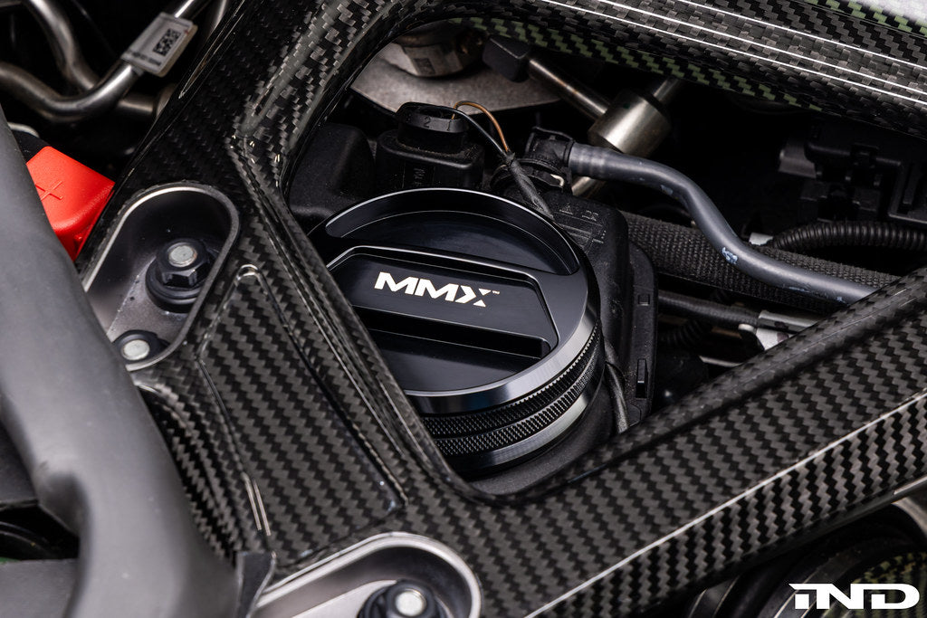 MMX Performance BMW billet coolant expansion cap for performance cooling systems, shown in close-up with polished metal finish.