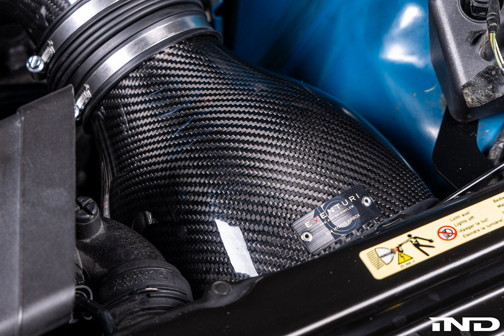 Eventuri E46 M3 hybrid carbon airbox system showcasing sleek carbon fiber construction and performance-enhancing design.