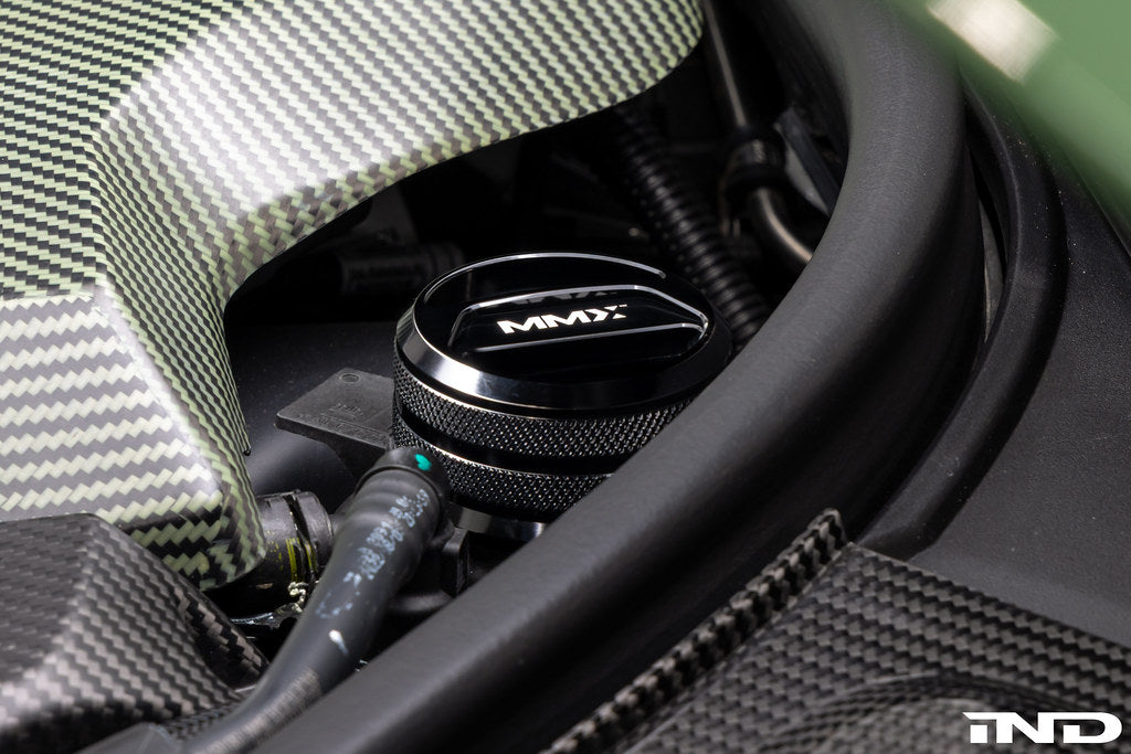 MMX Performance BMW billet coolant expansion cap showing polished metal finish and mounting details for performance cooling systems.