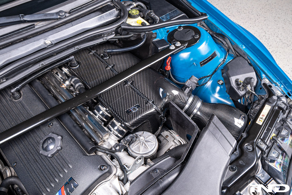 Eventuri E46 M3 hybrid carbon airbox system showcasing sleek carbon fiber construction and performance-enhancing design.