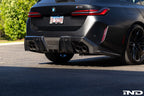 TREVORA G90 G99 M5 carbon fiber rear diffuser installed on exterior of vehicle, showcasing aerodynamic design and textured finish.