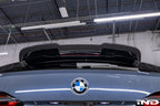 TREVORA G99 M5 carbon fiber rear roof spoiler mounted on car exterior, showcasing aerodynamic design and sleek finish.