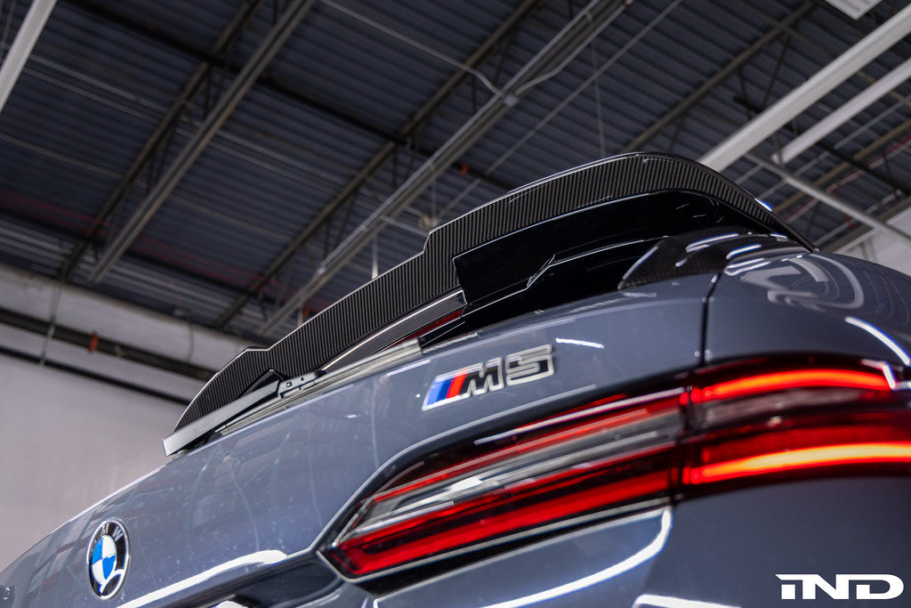 TREVORA G99 M5 carbon fiber rear roof spoiler installed on vehicle exterior, showcasing sleek aerodynamic design.