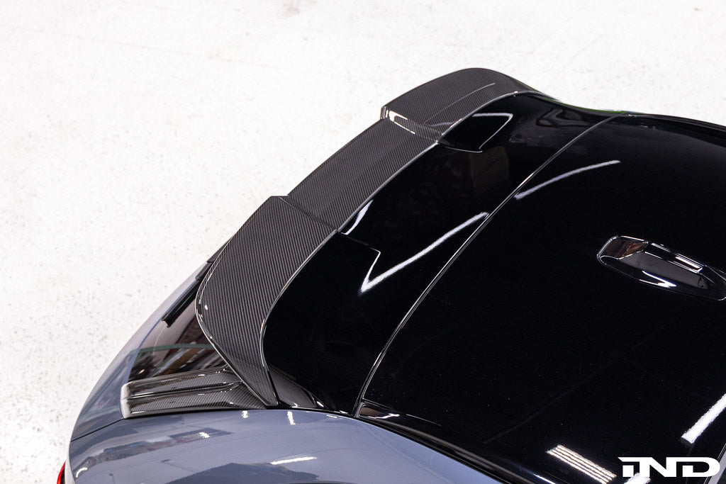 TREVORA G99 M5 carbon fiber rear roof spoiler mounted on a vehicle, showcasing its sleek exterior design and aerodynamic profile.