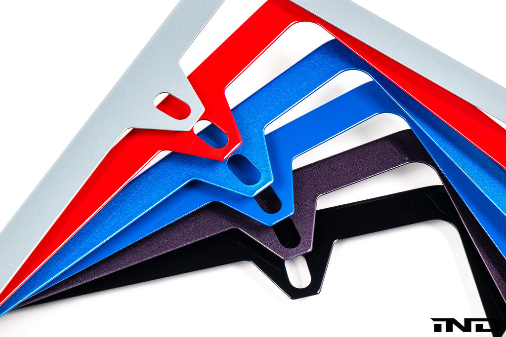 IND painted license plate frame for exterior use, featuring a sleek design and durable construction for vehicle customization.