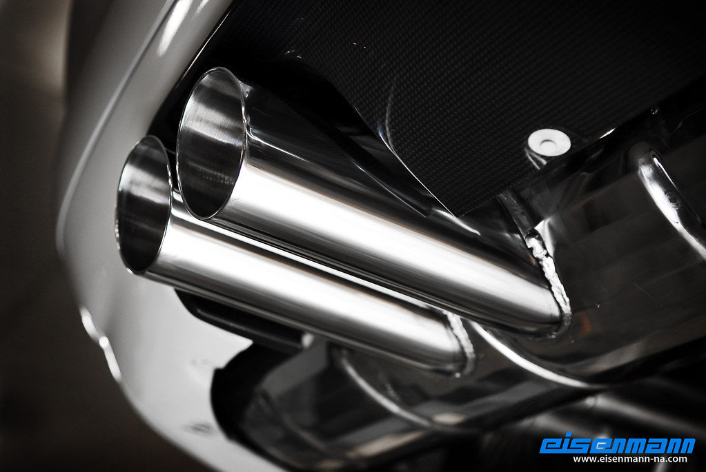 Eisenmann E46 M3 performance exhaust system with polished tips and dual exhaust outlets on a car.