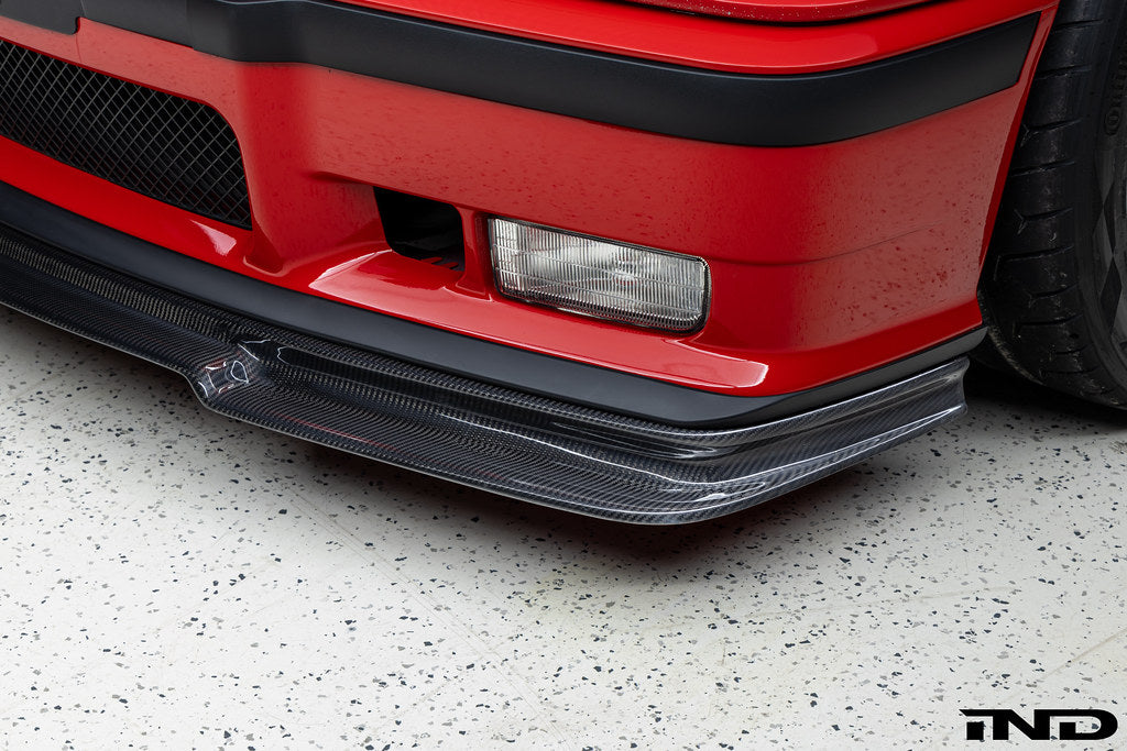 Alpha N E36 M3 Carbon GT Front Lip installed on red BMW E36 M3, exterior car modification for sporty aerodynamic look.